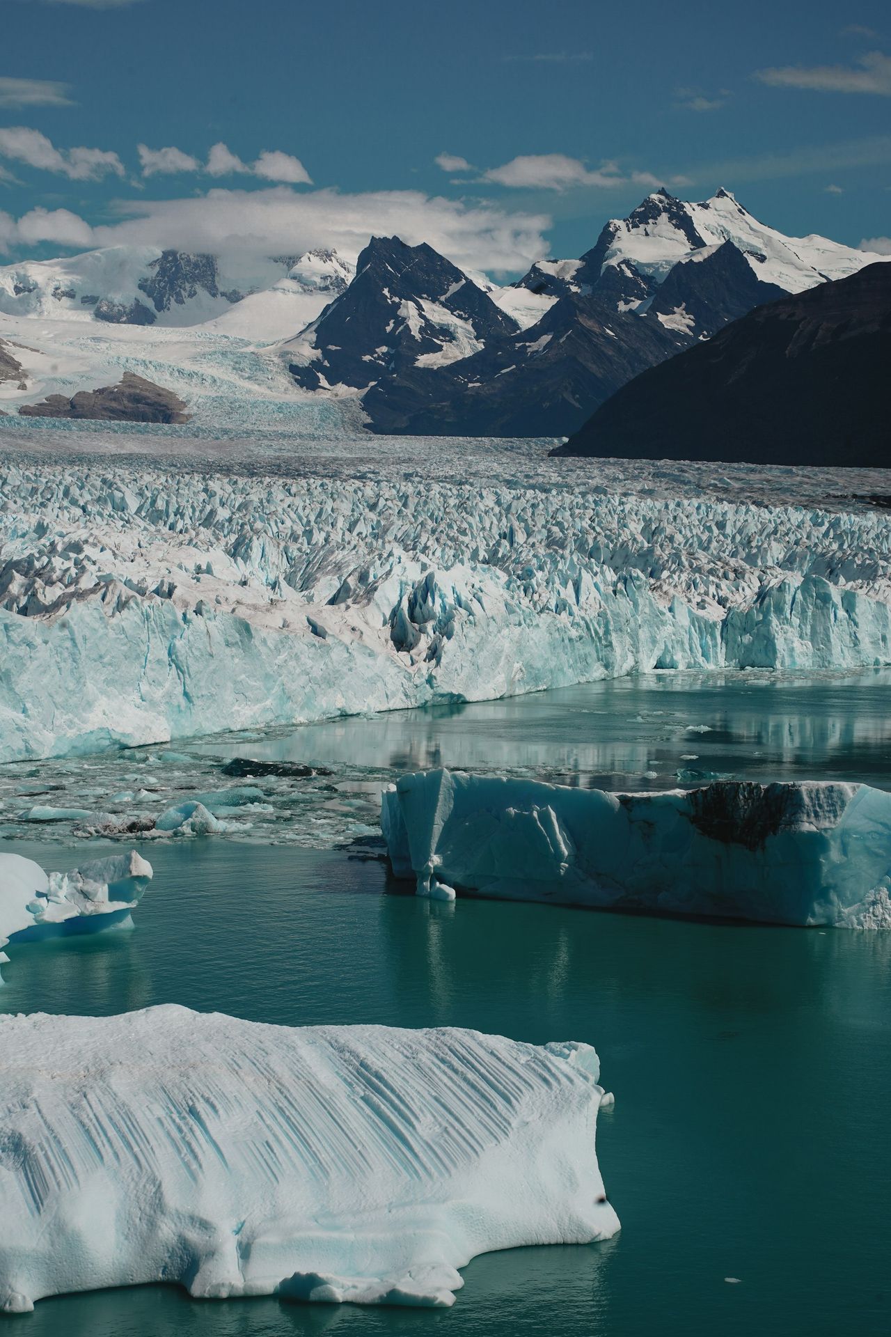 A group of icebergs floating in a body of water